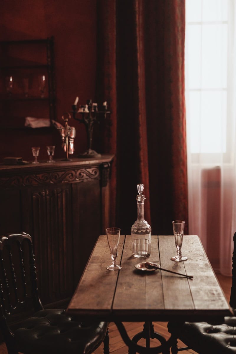 Recreated Paris dining room with red curtains, decanter and crystal glasses